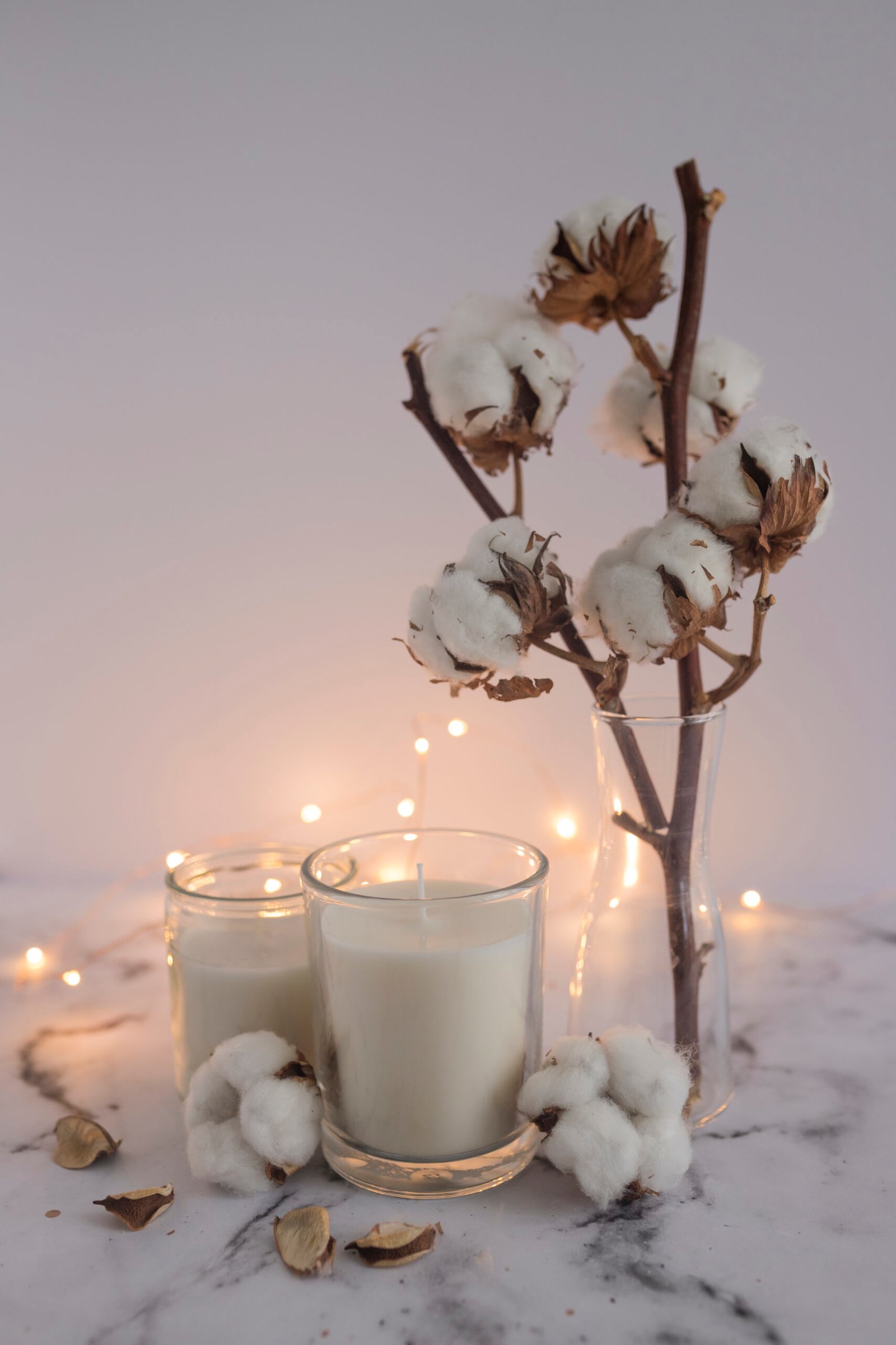candles decorated with cotton twig lighting equipments marble surface